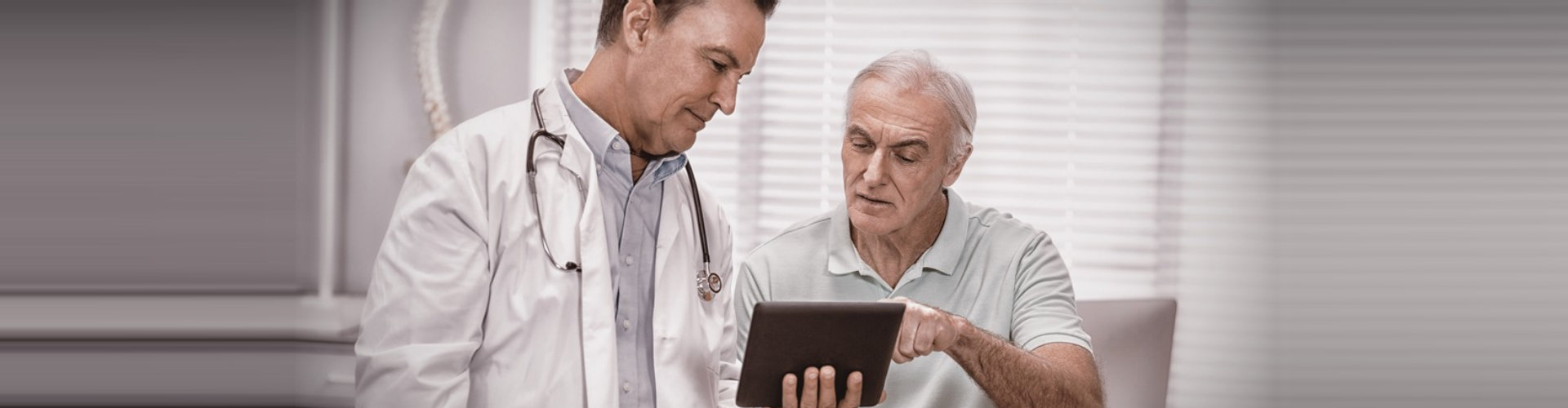 senior man consulting to doctor while using the tablet devices